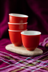 Four red cups on a flat stone - 746797836