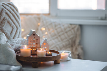 Concept of winter Christmas home aromatherapy, cozy bedroom interior, place for relaxation, detention, meditation. Bamboo tray, burning aromatic organic natural soy candles, sweet vanilla scent