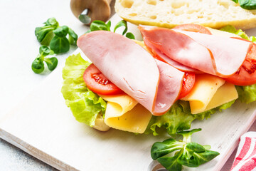 Ciabatta sandwich with lettuce, cheese, tomatoes and ham.