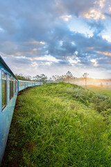 Fototapeta na wymiar A train meanders through the tea plantations in the highlands of Sri Lanka 