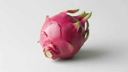 Obraz premium a close up of a dragon fruit on a white background with a bite taken out of one of the pieces.