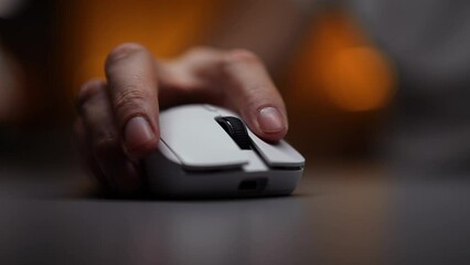 Close-up hands of unrecognizable male gamer playing in games sitting at desk with computer desktop pc in dark room with cozy bokeh neon light on background. Concept of modern online entertainment.
