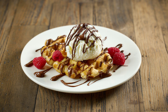 plate of belgian waffle with ice cream