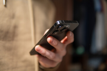 close-up of a man typing on a smartphone