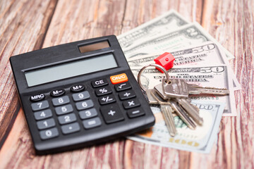 Housing market in the United States. Calculator next to keys and American dollars