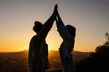Shadow of couple in scarf against light in nature