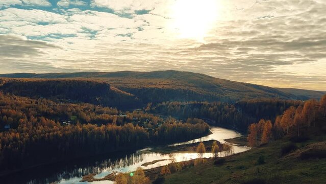 Autumn landscape of a forest river with a cloudy sky. The background of nature. Perm Region, Urals. The bank of the Kosva River in autumn is not far from the Scenery for the film The Heart of Parma