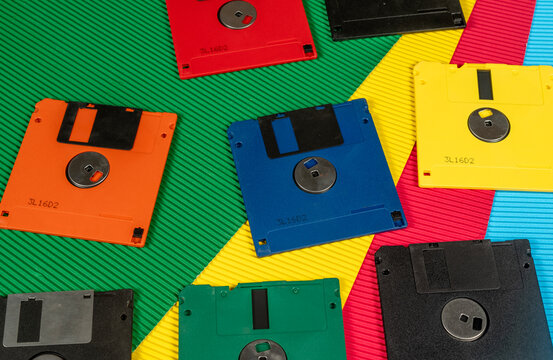 Colourful vintage floppy disks on contrast color background banner