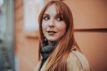 Fototapeta premium Close up of a ginger lady looking away outdoors.