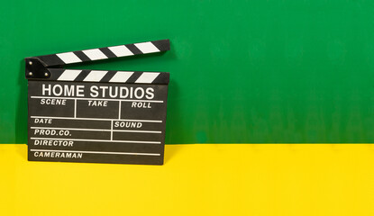 clapperboard closeup with colorful wall- blogging and movies theme