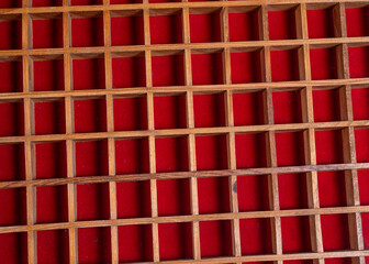 Closeup view of Wooden isolated boxes with red fabric making abstract bg