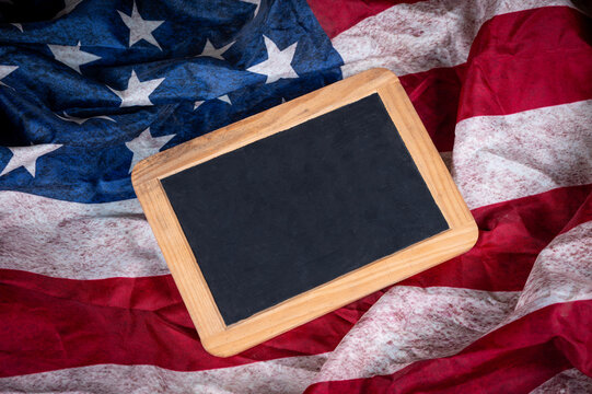 Empty Slate board with copy space onto USA flag in background