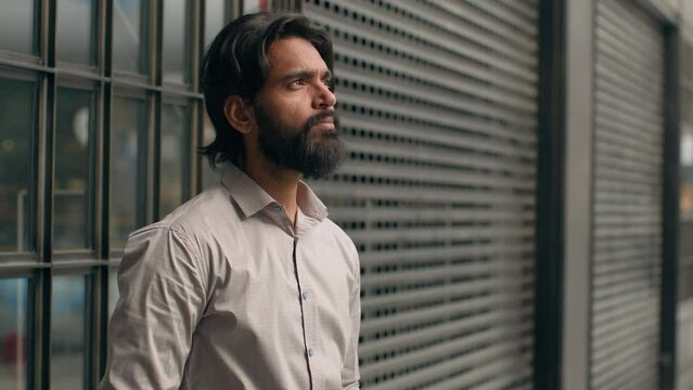 Serious pensive indian man thoughtful male businessman bearded entrepreneur thinking ponder business issues alone dreamy face arabian guy customer waiting think deep in thought contemplating dreaming