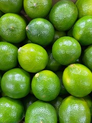 Fresh key limes .Lemon as texture background .

