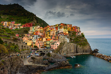 The colorful town of Manarola with cloudy dramatic sky,  Cinque Terre, Liguria, Italy