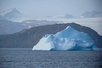 Turquoise iceberg and mainland ice-sheet, East Greenland