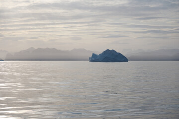 East Greenland coast and iceberg at sunset