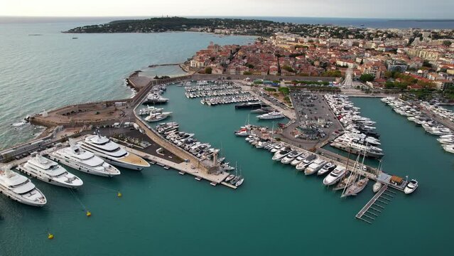 Super Mega Yachts in the French Riviera in the port of Antibes - Aerial sunrise flyover