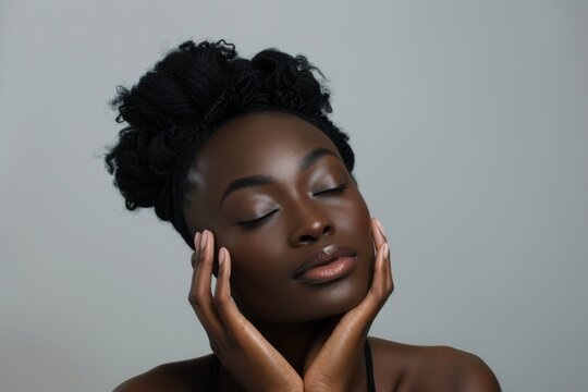 African woman with clean skin doing facial massage for beauty