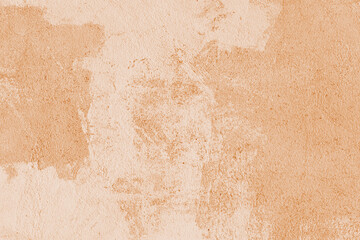 Old stucco plaster surface, concrete wall background, close up grunge texture of orange painted...