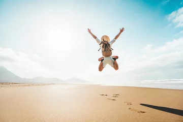 Foto op Canvas Happy traveler with hands up jumping at the beach - Delightful man enjoying success and freedom outdoors - Wanderlust, wellbeing, travel and summertime holidays concept © Davide Angelini