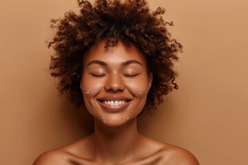 Joyful African American woman with curly hair delighting in her refreshed skin after a spa treatment against a brown backdrop with her eyes closed in happines - obrazy, fototapety, plakaty