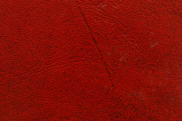A bold and vibrant red textured wall, providing a detailed and colorful backdrop for creative...
