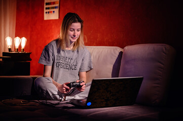 An adult gamer is engrossed in a virtual game, the soft glow of the screen illuminating her...