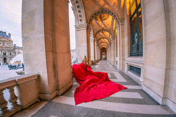 Beautiful pretty blonde woman in red long dress in Paris, France. Eiffel Tower, Louvre,  Galeries LaFayette background. Fashion tourist travel concept.
