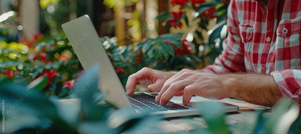 Fototapete young farmer using laptop with blurred background, perfect for adding text or graphics