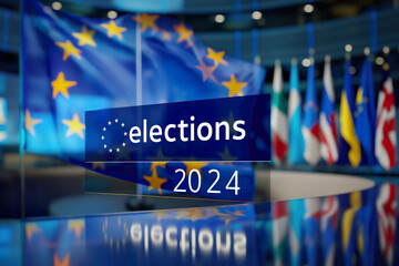 Prominent blue election sign placed next to flags, including the flag of Europe in the background.