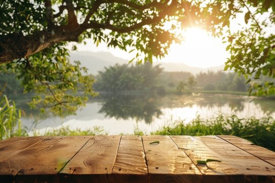 Wooden table by lake on farm displaying food perfume products with nature background farm table by river and grass Morning sunlight