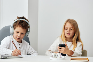 Teenagers Studying Online at Home Using Laptops and Headphones