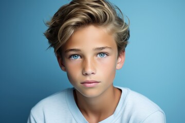 Portrait of a young boy with blond hair and blue eyes.