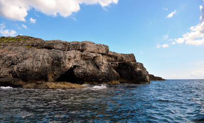 Fototapeta na wymiar The caves of the ionian Sea side of Santa Maria di Leuca seen from the tourist boat