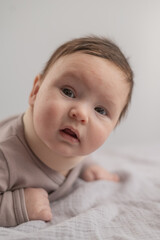 Portrait of a newborn baby lying on his stomach in an orthopedic collar.