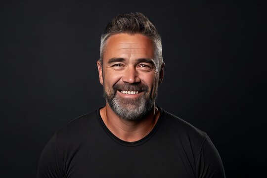 Portrait of a handsome middle-aged man on a black background.