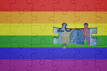 puzzle with the rainbow gay pride flag and euro banknote. finance concept