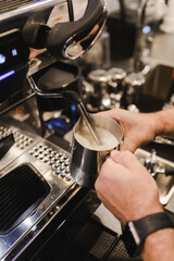 Steaming Milk for Latte in Coffee Shop