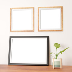 double thin wooden frames on wall and a dark large landscape photo frame