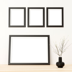 portrait frames on the wall and large landscape frame on top of the shelf