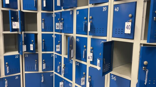 Rows of metal storage lockers in a supermarket, school, college, university, gym, pool, airport or other public place