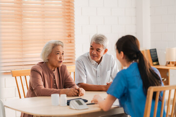 Health insurance service, Young Asian caregiver nurse examine senior man or woman patient at home....
