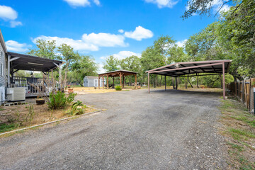 Open space with gravel path and shaded areas in a relaxed outdoor setting during daytime hours