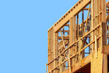 Wooden framework for a residential building with a blue sky