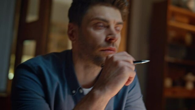 Unknown author writing notebook at evening table closeup. Man thinking ideas 