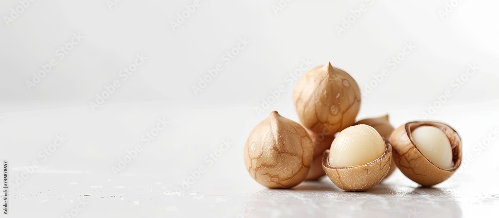Poster a collection of various nuts such as almonds, walnuts, and pecans neatly stacked on top of a clean w