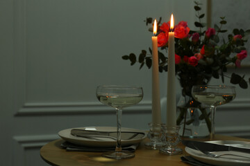 Romantic table setting with candles and flowers, space for text