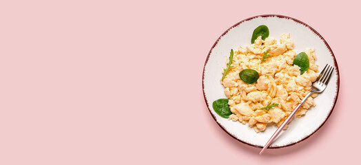 Plate with delicious scrambled eggs and herbs on pink background with space for text