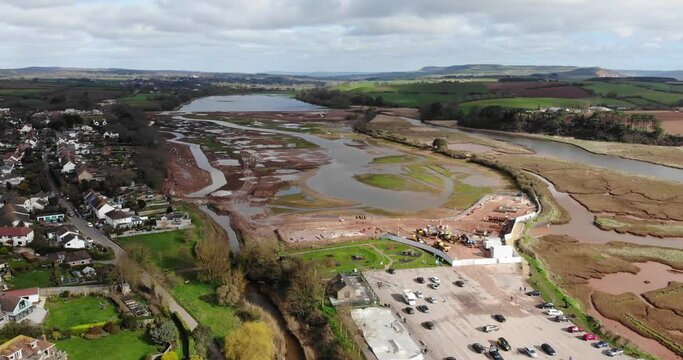 Aerial panning left shot of the River Otter Restoration Project works at Budleigh Salterton Devon England